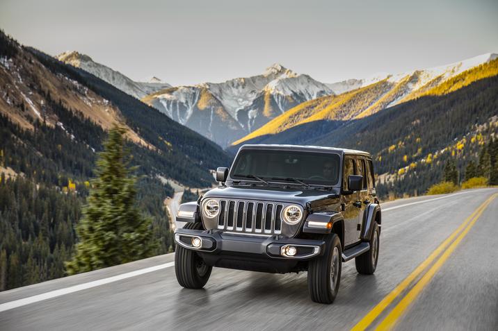 A man driving a jeep wrangler car