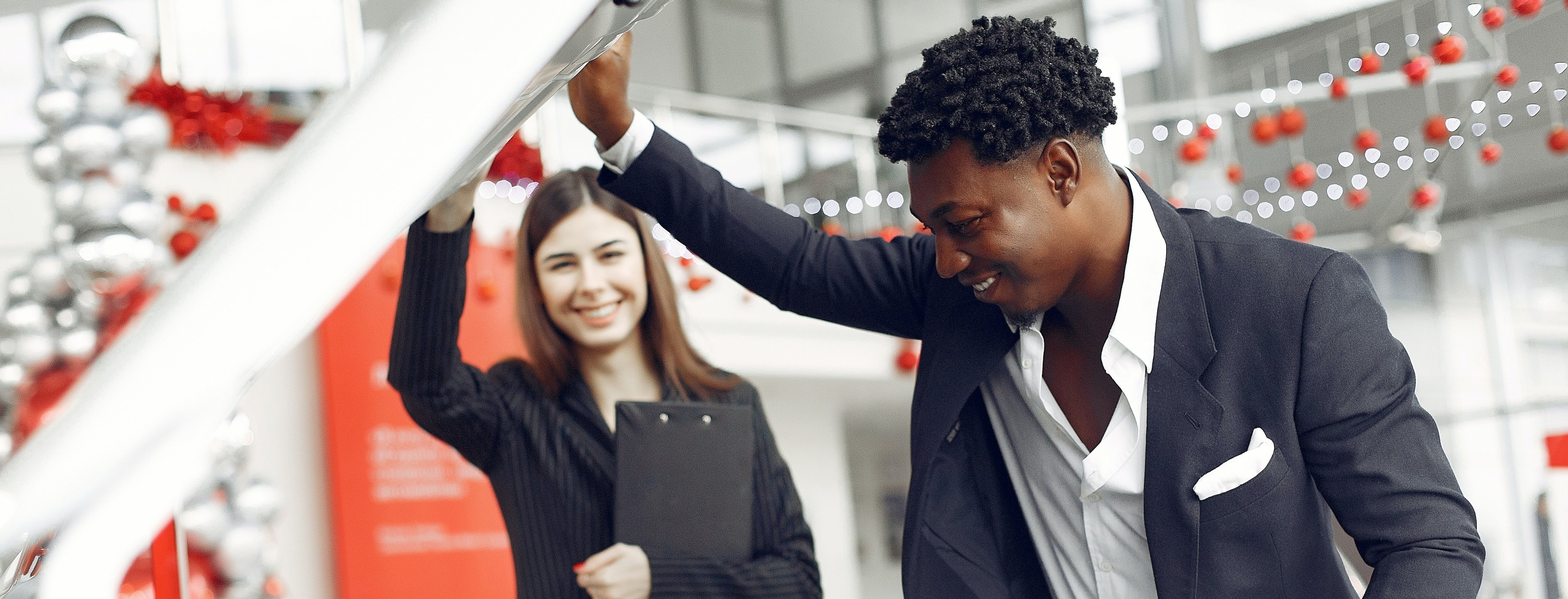 car buyer looking under the hood