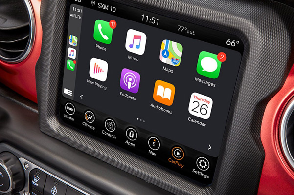 A close-up of the Uconnect touchscreen in the 2021 Jeep Wrangler Rubicon, displaying Apple CarPlay selections.