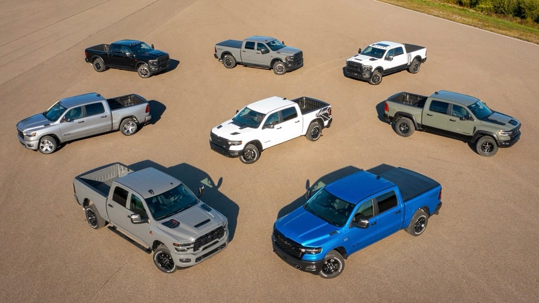 Aerial view of several 2026 Ram 1500 trucks in different colors parked on a large paved lot.